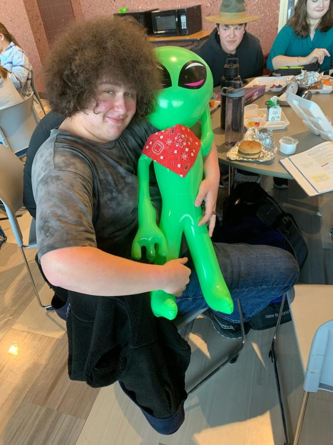 Sophomore Aaden Jackson cuddles “My Child” in front of his friends during lunch.