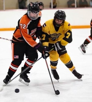 Number 17 Joey Evans battling for the puck in a game with her girls team against Highland Hills Girls Black team.