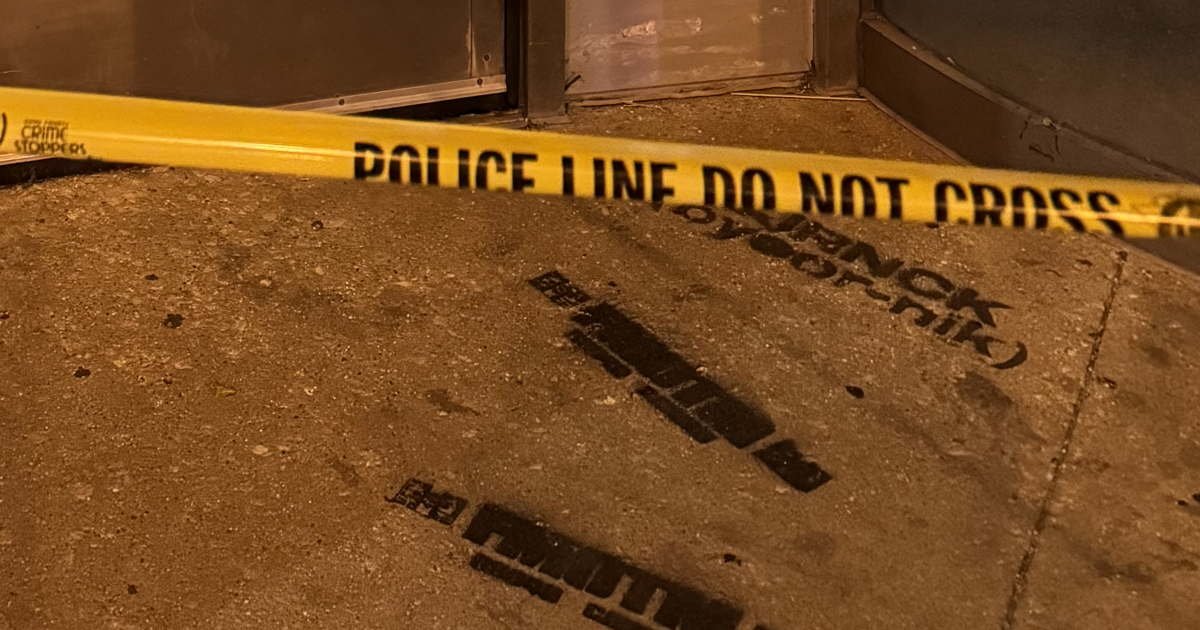 Police tape and evidence markers mark a Chicago street after a weekend shooting